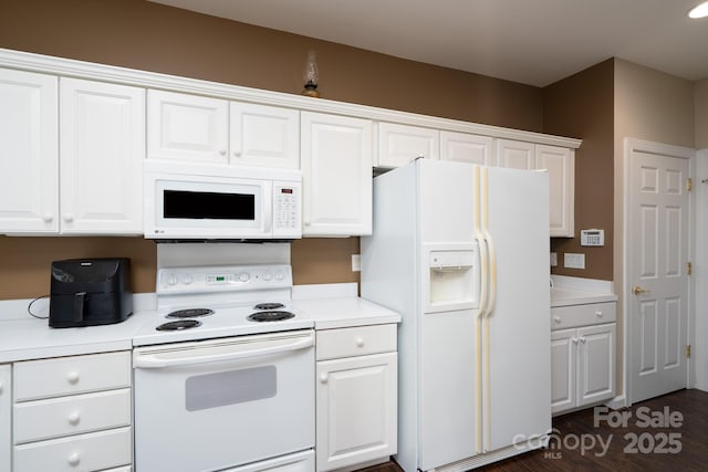 kitchen featuring white appliances and white cabinets