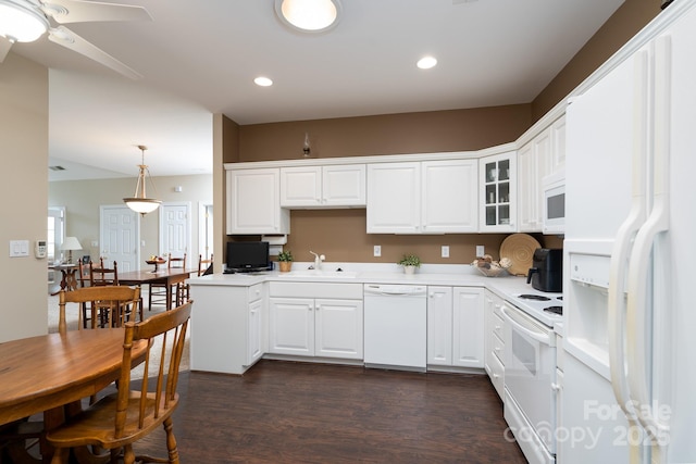 kitchen with white appliances, white cabinetry, sink, and decorative light fixtures