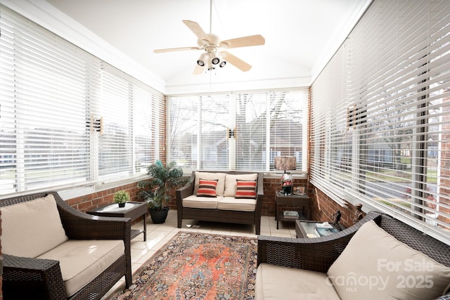 sunroom with ceiling fan and lofted ceiling