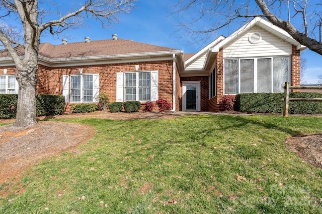 rear view of property with a lawn