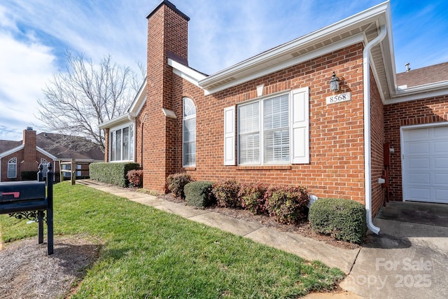 view of property exterior featuring a garage and a lawn