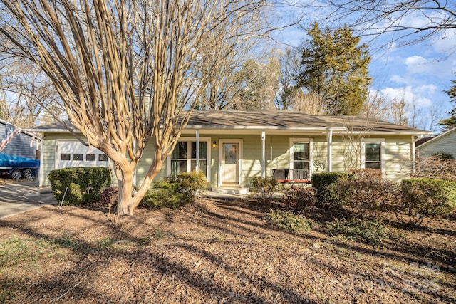 single story home featuring a garage and a porch