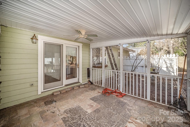 unfurnished sunroom with ceiling fan