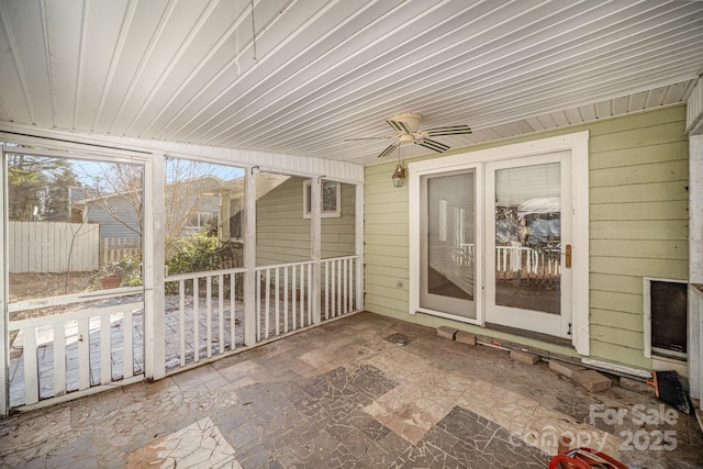 unfurnished sunroom featuring ceiling fan and wooden ceiling