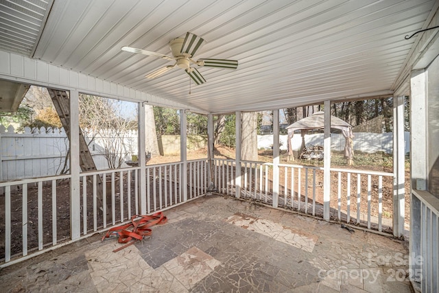 unfurnished sunroom featuring ceiling fan