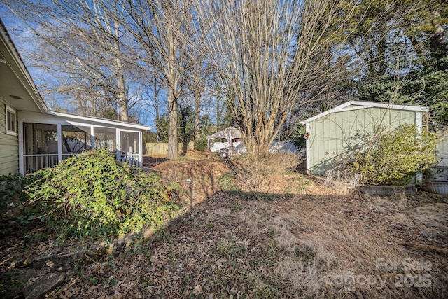 view of yard featuring a sunroom and a gazebo