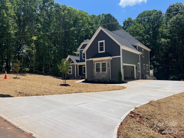 7221 Static Way Unit 13, Sherrills Ford, NC 28673 - view of front facade with board and batten siding, stone siding, driveway, and a garage