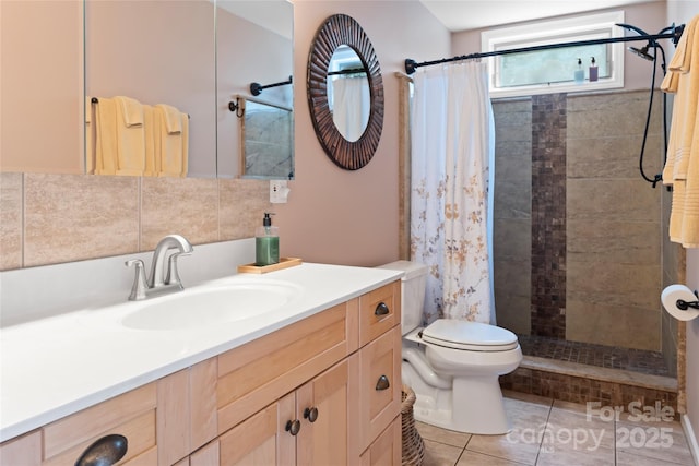 full bath with tasteful backsplash, toilet, vanity, tiled shower, and tile patterned floors