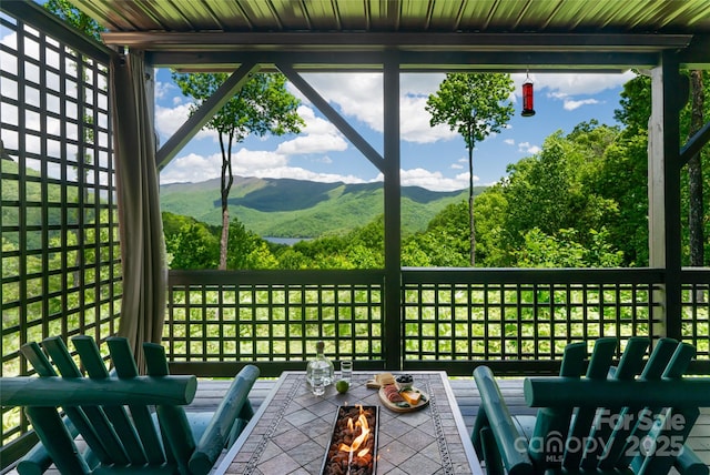 unfurnished sunroom with a mountain view