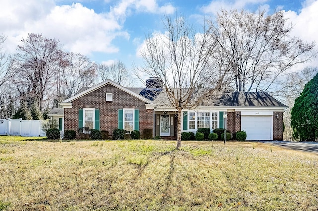 ranch-style house with brick siding, fence, a front yard, driveway, and an attached garage