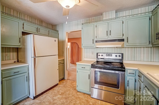 kitchen with wallpapered walls, electric range, freestanding refrigerator, light countertops, and under cabinet range hood