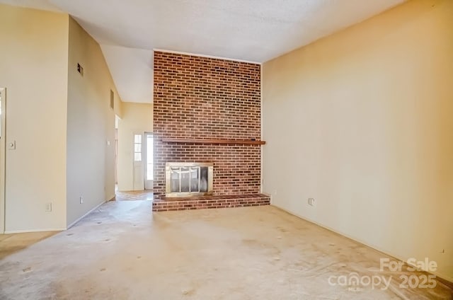 unfurnished living room with visible vents, a textured ceiling, and a fireplace