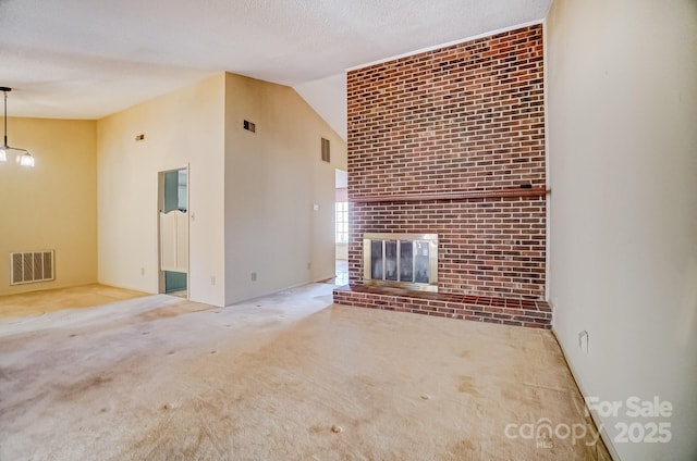 unfurnished living room with visible vents, a textured ceiling, and carpet flooring