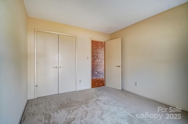 unfurnished bedroom featuring a closet and carpet floors