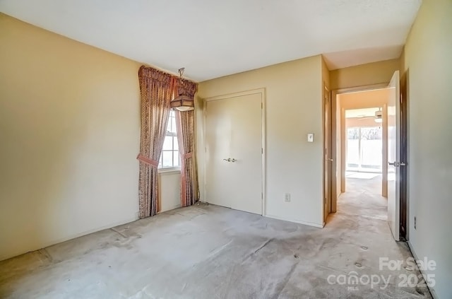 unfurnished bedroom featuring a closet and concrete floors