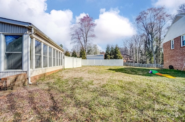 view of yard with fence and a sunroom