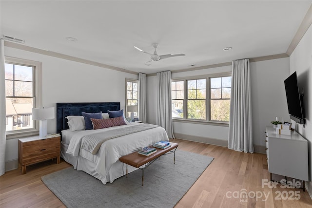 bedroom with ceiling fan, light wood-type flooring, and crown molding