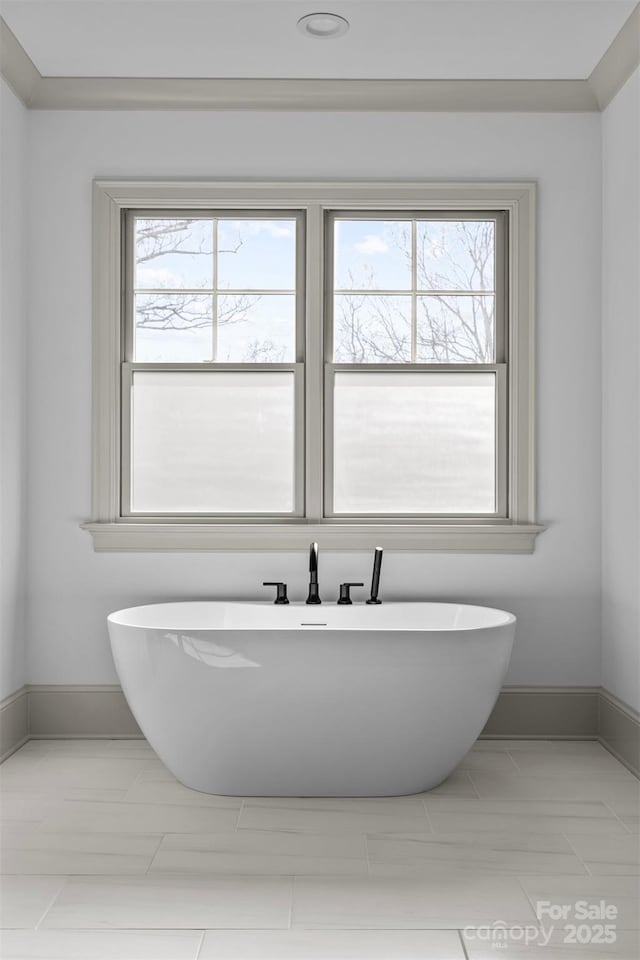 bathroom featuring a bathing tub and a wealth of natural light