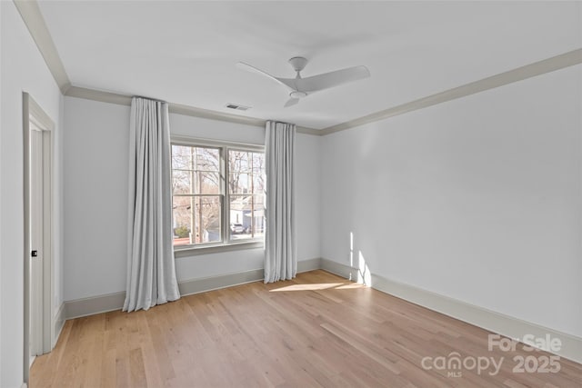 spare room featuring light wood-type flooring and ceiling fan