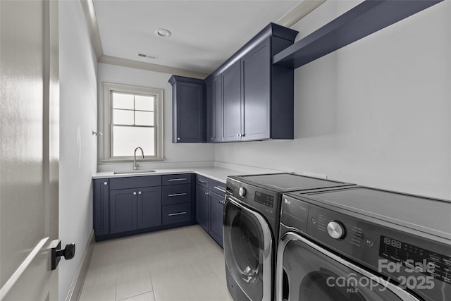 washroom featuring cabinets, washer and dryer, and sink