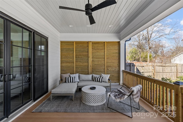 sunroom featuring ceiling fan, wood ceiling, and a wealth of natural light