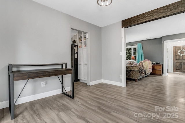 office with baseboards and wood finished floors