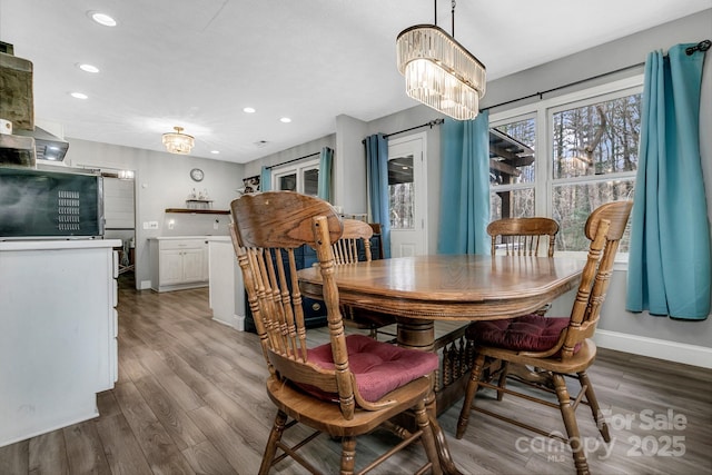 dining area featuring recessed lighting, a chandelier, baseboards, and wood finished floors