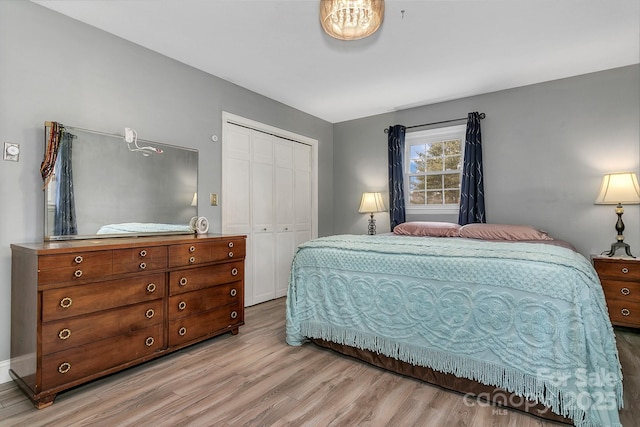 bedroom featuring a closet and light wood-type flooring