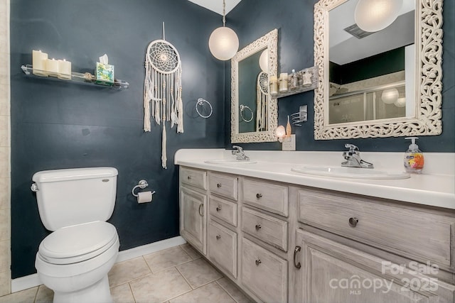 full bathroom with tile patterned floors, toilet, a stall shower, and a sink