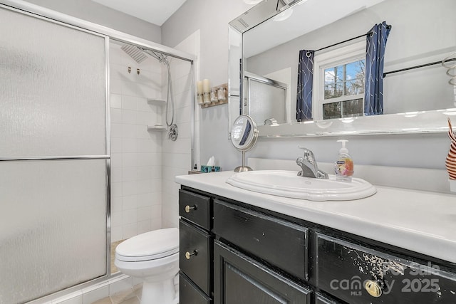 full bathroom featuring tile patterned floors, toilet, a stall shower, and vanity