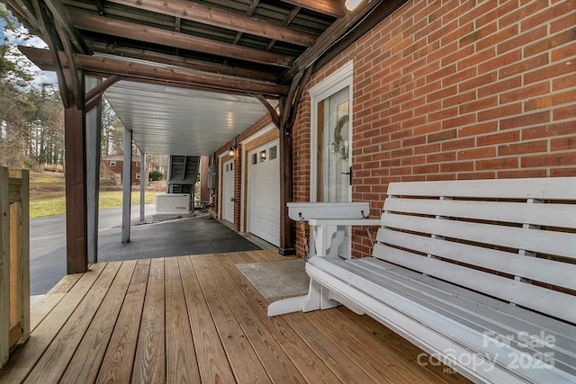 wooden deck featuring an attached garage