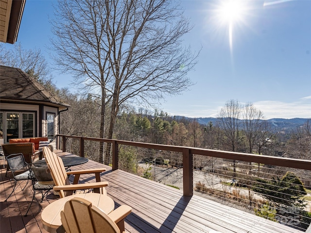 wooden deck with a mountain view