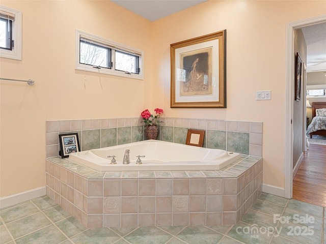 bathroom featuring tiled tub and tile patterned floors