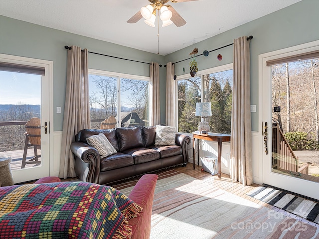 living room with hardwood / wood-style flooring, a healthy amount of sunlight, and ceiling fan