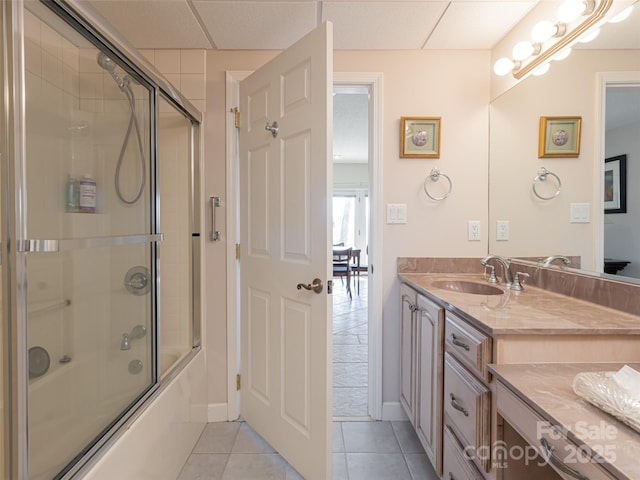 bathroom with vanity, bath / shower combo with glass door, and tile patterned floors