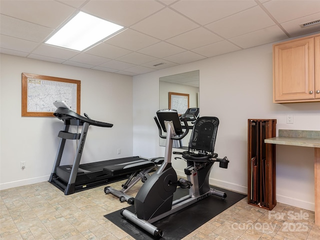 workout area featuring a paneled ceiling