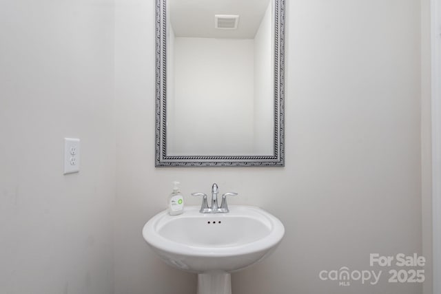 bathroom with visible vents and a sink