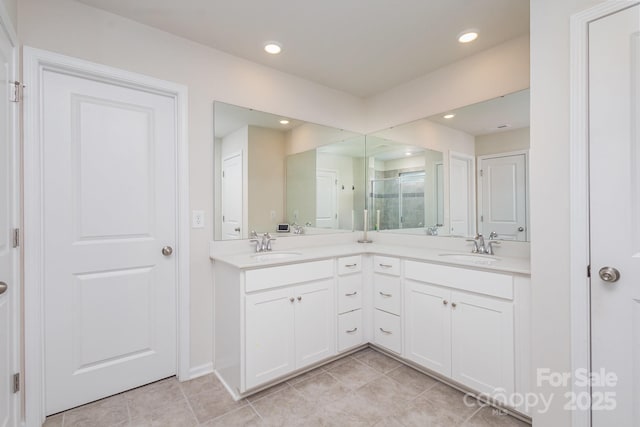 bathroom featuring recessed lighting, a sink, and double vanity