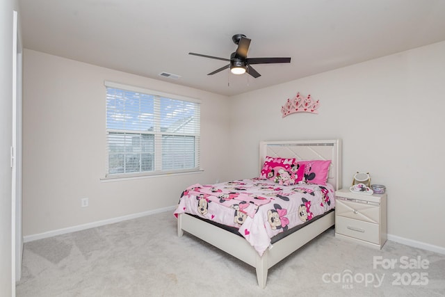 carpeted bedroom with a ceiling fan, visible vents, and baseboards