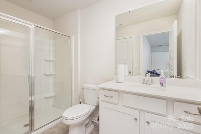 full bathroom with a stall shower, tile patterned flooring, vanity, and toilet