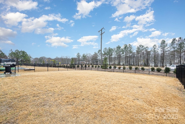 view of property's community with fence and a lawn