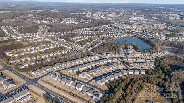 birds eye view of property featuring a water view and a residential view