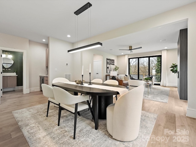 dining space featuring visible vents, recessed lighting, light wood-type flooring, and baseboards