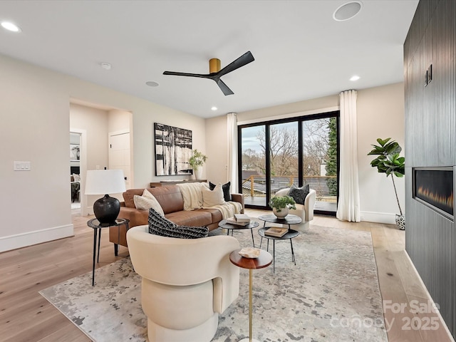 living room with a ceiling fan, light wood-style flooring, and recessed lighting