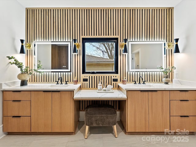 full bathroom with two vanities and a sink