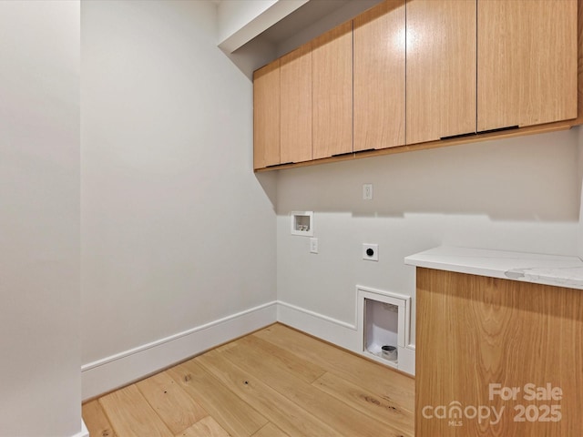 washroom with cabinet space, light wood finished floors, baseboards, hookup for an electric dryer, and hookup for a washing machine