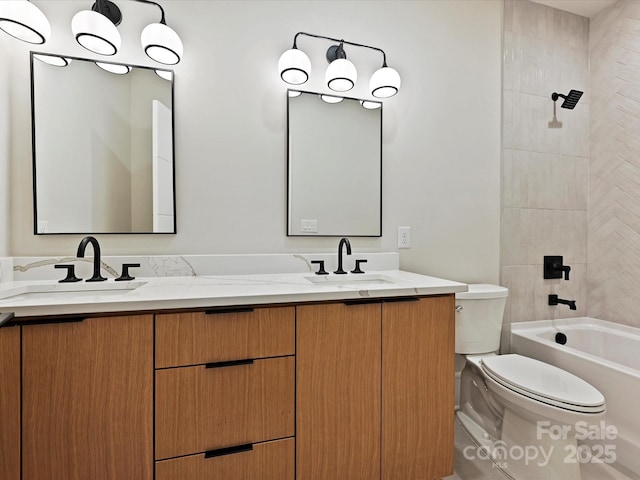 bathroom with a sink, toilet, and double vanity