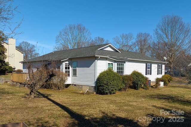 view of property exterior featuring a shingled roof, crawl space, and a yard