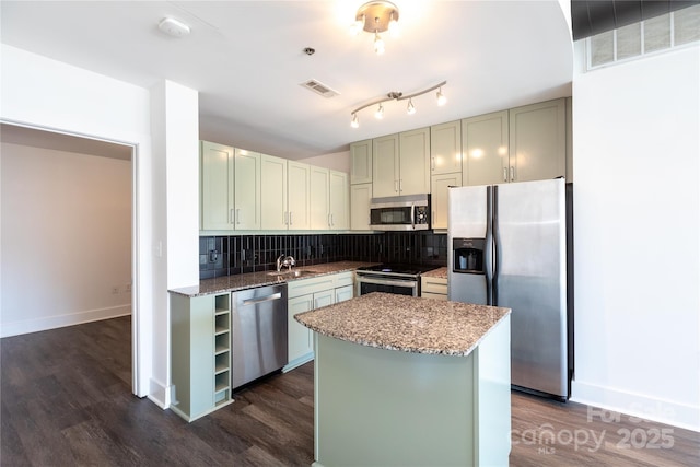 kitchen featuring tasteful backsplash, light stone countertops, visible vents, and appliances with stainless steel finishes