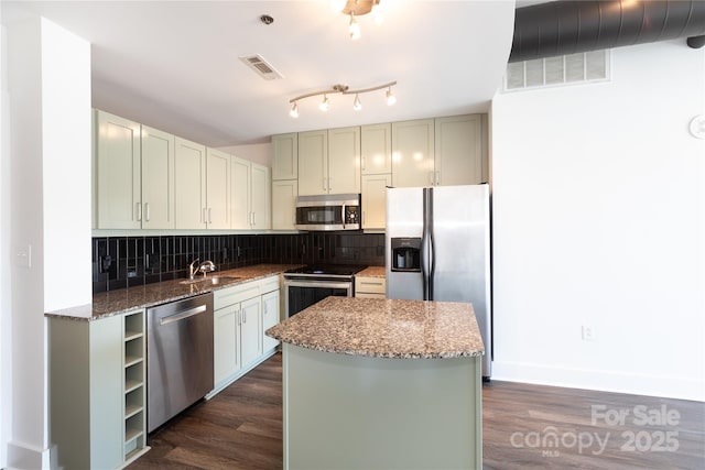 kitchen with tasteful backsplash, visible vents, stainless steel appliances, and light stone counters